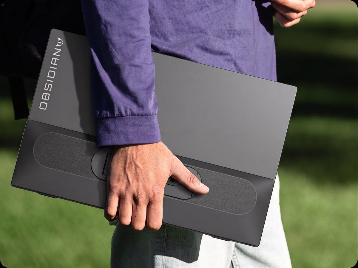 Person carrying Obsidian Portable V2 under one arm