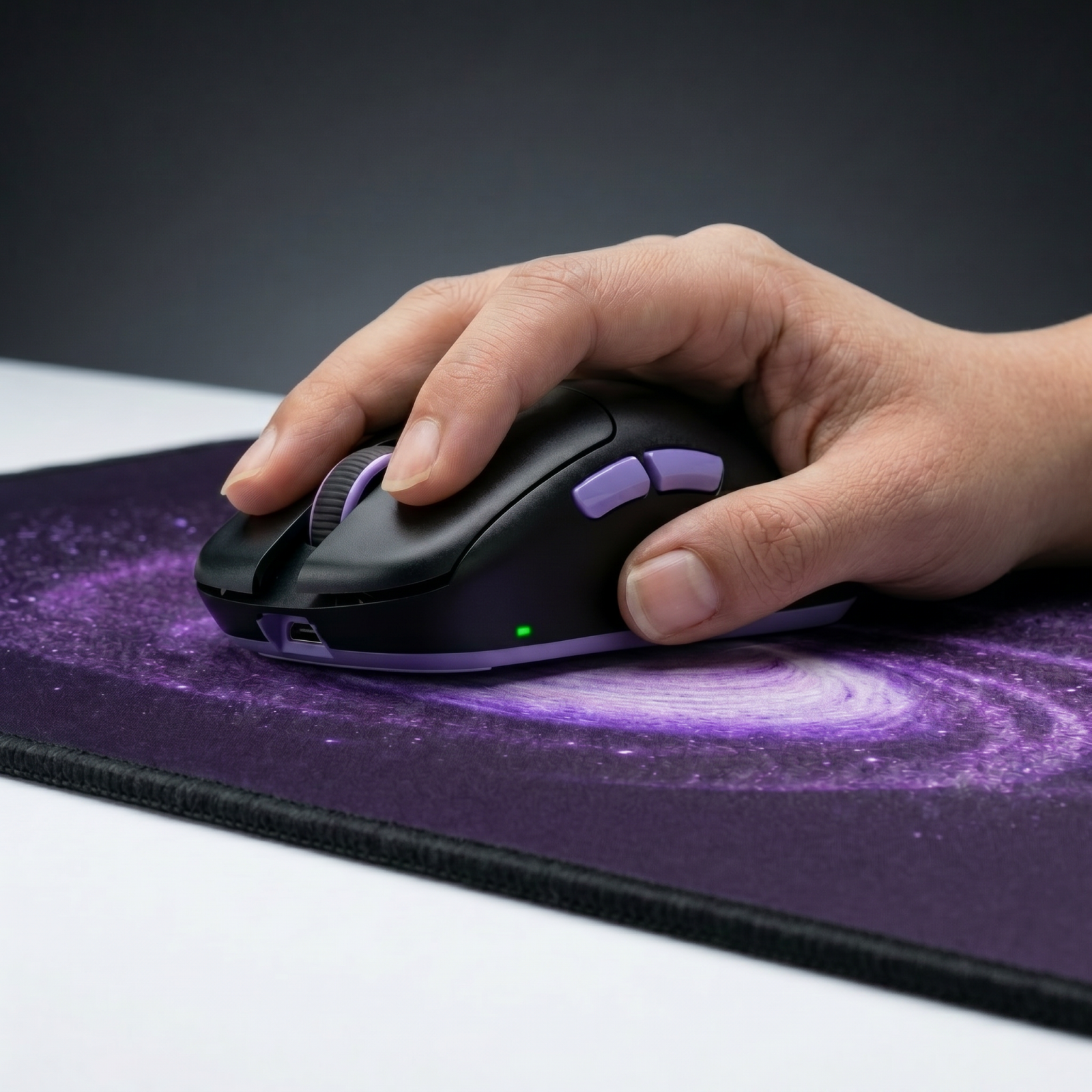 Hand resting on mouse over Terra deskmat