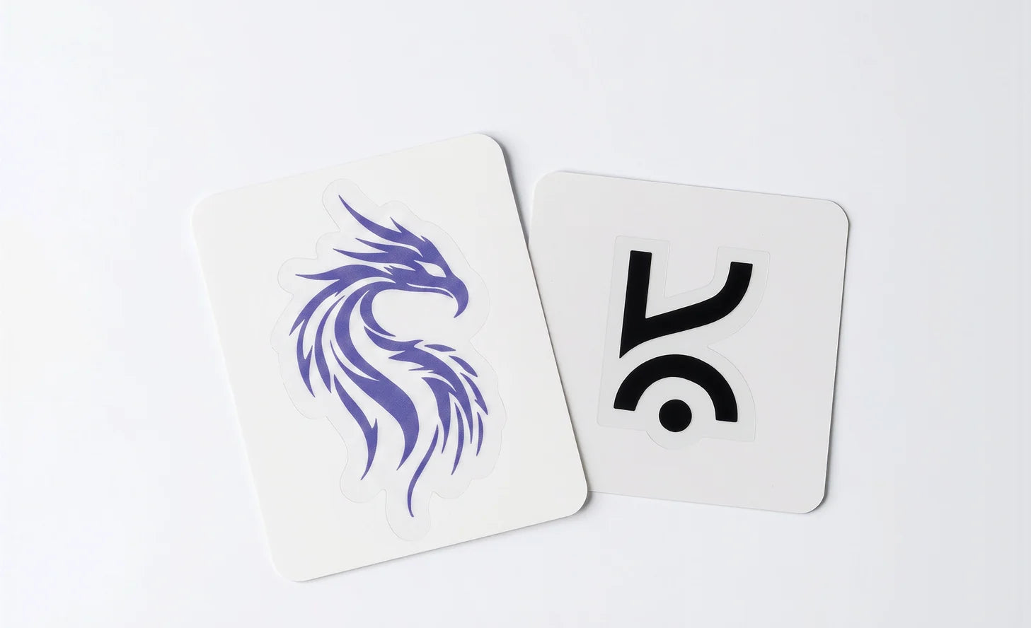 Two Kreo stickers, a dragon and the wordmark